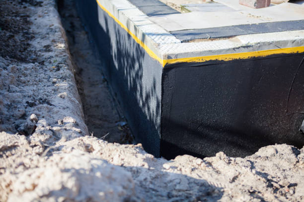 Professional Basement Waterproofing technician working in Potomac, MD